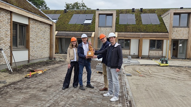 Wethouder Lambert Polinder en projectleider, beleidsmedewerker Arno Voskamp reiken de Klimaatestafette uit aan Wim Prins en Willemijn Prins